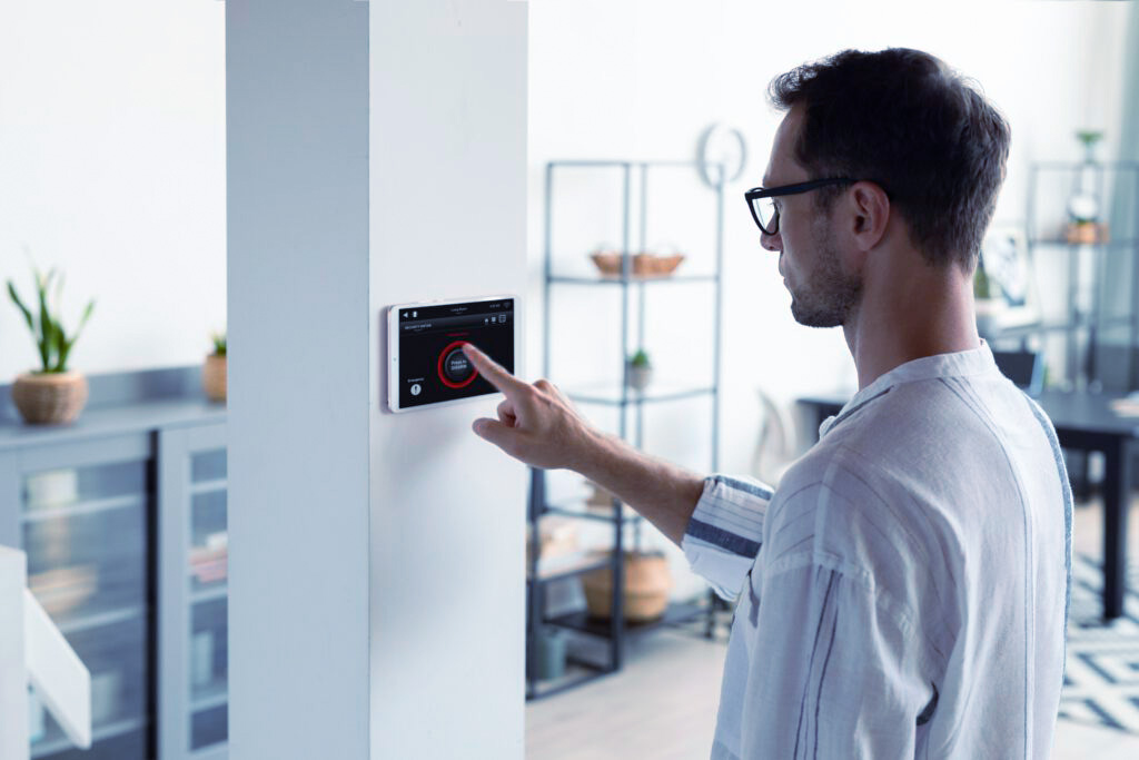A customer operating a smart home application on the wall